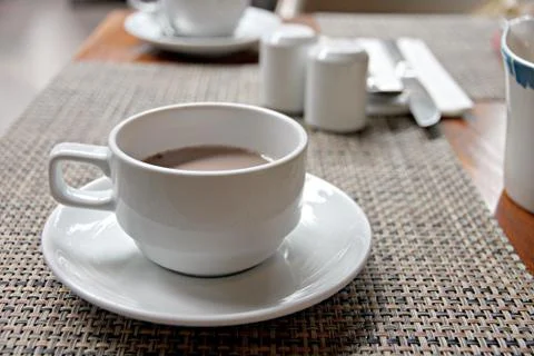 Hot cocoa in white cup on the table. Stock Photos