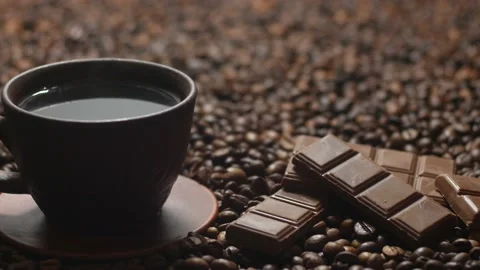 Hot coffee and chocolate on the background of coffee beans Stock Footage 108611073