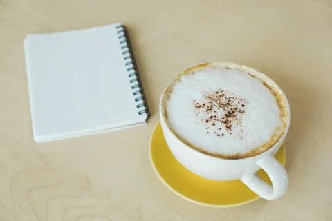 Hot coffee and empty book on wooden table of brown Stock Photos