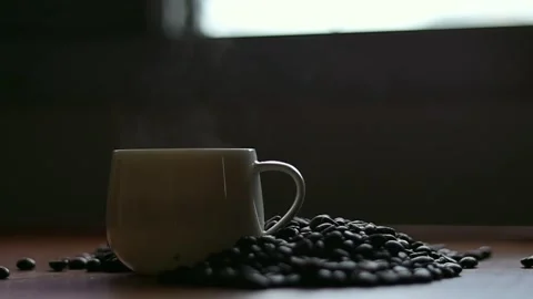 Hot coffee and roasted coffee beans on the table, slow motion, Dolly shotCup. Stock Footage 163569005