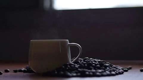 Hot coffee and roasted coffee beans on the table, slow motion, Dolly shotCup Stock Footage 163569007