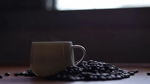 Hot coffee and roasted coffee beans on the table, slow motion, Dolly shotCup. Stock Footage 163569014