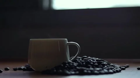 Hot coffee and roasted coffee beans on the table, slow motion, Dolly shotCup. Stock Footage 163569015