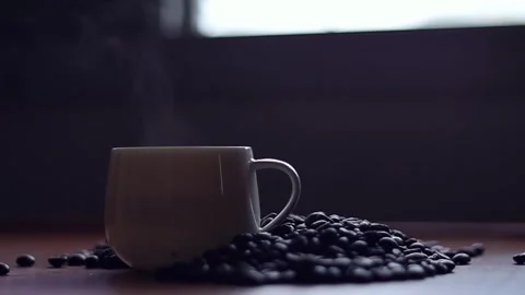 Hot coffee and roasted coffee beans on the table, slow motion, Dolly shotCup. Stock Footage 163569016