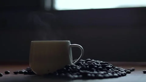 Hot coffee and roasted coffee beans on the table, slow motion, Dolly shotCup. Stock Footage 163569020
