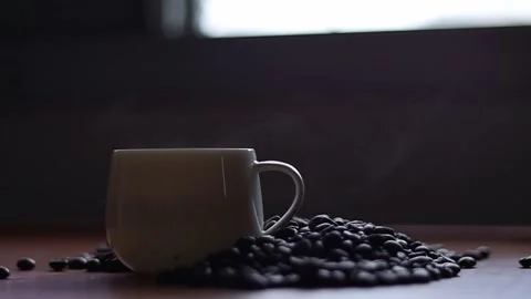 Hot coffee and roasted coffee beans on the table, slow motion, Dolly shotCup. Stock Footage 163569022