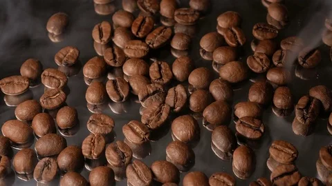 Hot coffee beans close-up with mirror reflection, with smoke Stock Footage 74775063