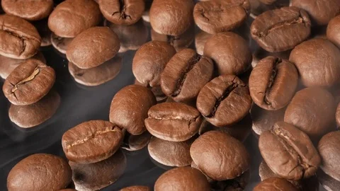 Hot coffee beans close-up with mirror reflection, with smoke Stock Footage 74775531