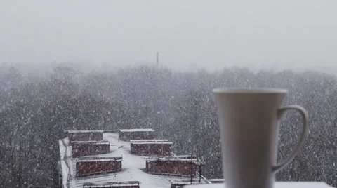 Hot coffee being poured into the cup, Snow outside. Stock Footage