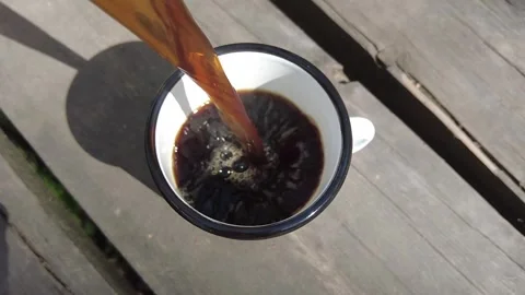 Hot coffee being poured into white enamel mug 库存影片 333585554