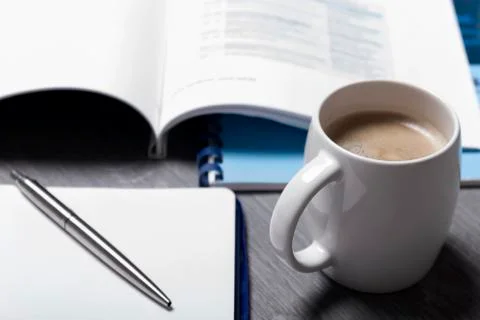 Hot coffee with blank paper note on wood background Stock Photos