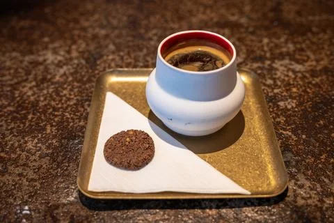 Hot Coffee in Ceramic Cup on Brass Tray with Chocolate Cookie and Napkin Stock Photos