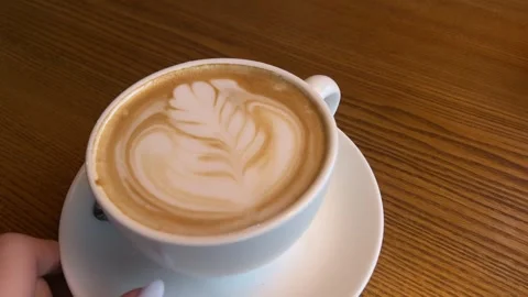 Hot Coffee Cup With Beautiful Bartender Pattern Standing On Wooden Table Stock Footage 303495884