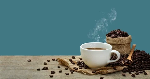 Hot Coffee cup with Coffee beans on the wooden table Stock Footage 104894908