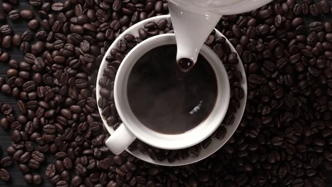 Hot coffee cup with coffee beans on the wooden table Stock Footage 105223621