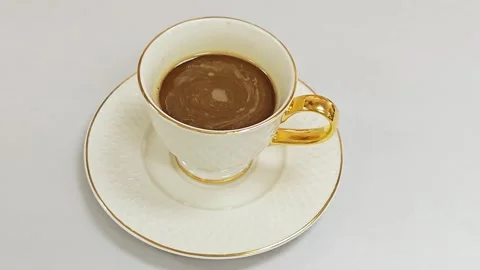 Hot coffee cup with elegant golden handle on white background. 스톡 동영상 344035368