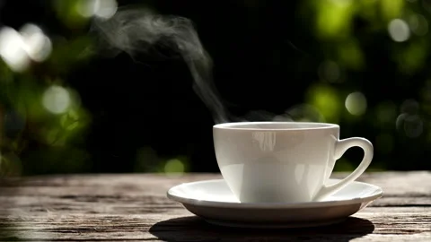 Hot coffee cup with steaming smoke in natural sunlight overlays, 4K Stock Footage 205533441