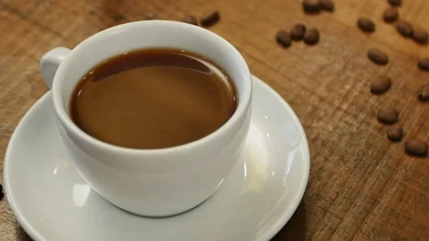 Hot coffee in a cup on the table Stock Footage