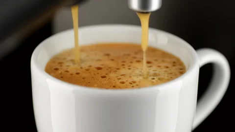 Hot coffee espresso from coffee machine pour in white cup Stock Footage 248135046