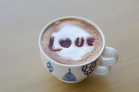 Hot coffee with foam milk art love pattern Stock Photos