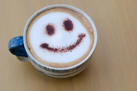 Hot coffee with foam milk art smile pattern Stock Photos