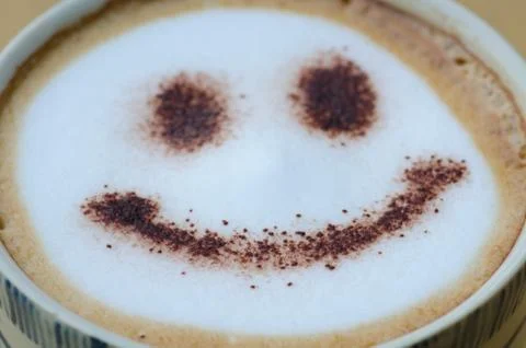 Hot coffee with foam milk art smile pattern Stock Photos