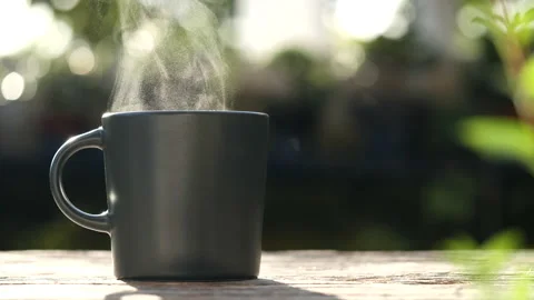 Hot Coffee Mug. Close-up natural steam smoke of coffee from black coffee cup Stock Footage 237409393