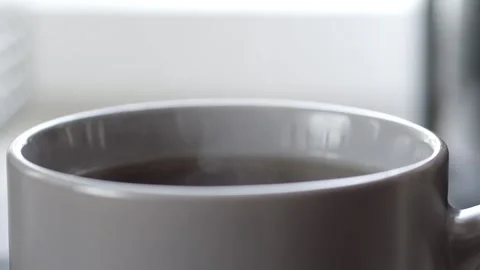 Hot coffee mug steaming in slow motion Stock Footage 305878462