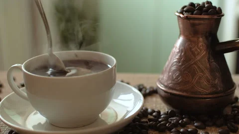 Hot coffee mug on the table. Turk for coffee full of beans. HD Vídeo Stock 101691746