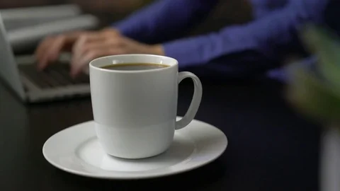 Hot coffee near a man using laptop Stock Footage 85447033