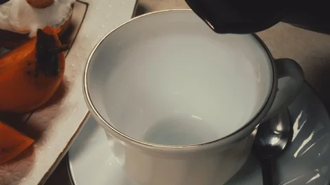 Hot coffee pour into a Cup close-up 4 K Stock Footage 100708552