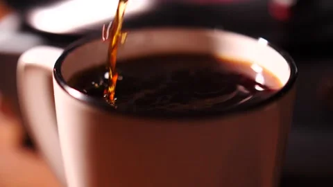 Hot coffee pouring into an almost full mug with a splash Stock Footage 153664973