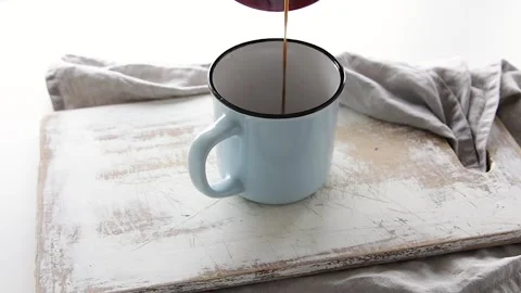 Hot coffee pouring into cup Stock Footage 134304623