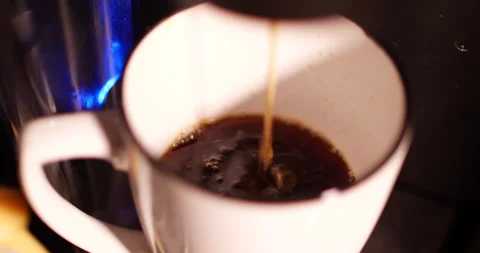 Hot coffee splashing inside a ceramic mug as it is poured Video stock 153666735