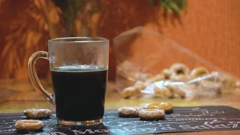 Hot coffee in a transparent mug on the table and drying 4K Stock Footage 98320233