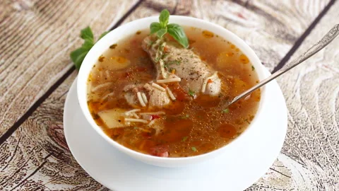 Hot cooked chicken and noodle soup in a plate Stock Footage 290431180