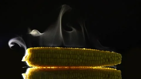 Hot corn with steam on black mirror. Side view. Stock Footage 171366096