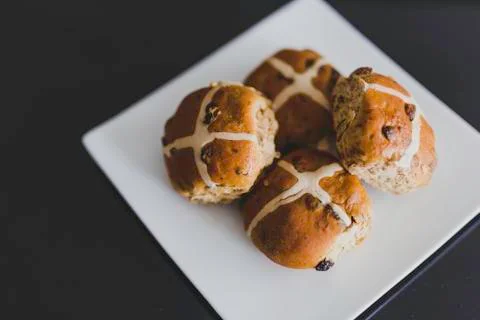 Hot cross buns on black table Stock Photos