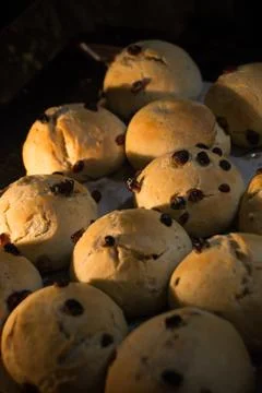 Hot cross buns in oven. Easter sweet cakes freshly baked lit by electric oven Stock Photos