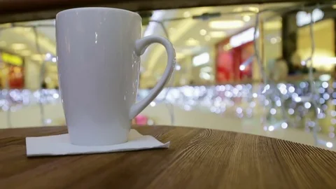 Hot cup of coffee on table in cafe Stock Footage 70693432