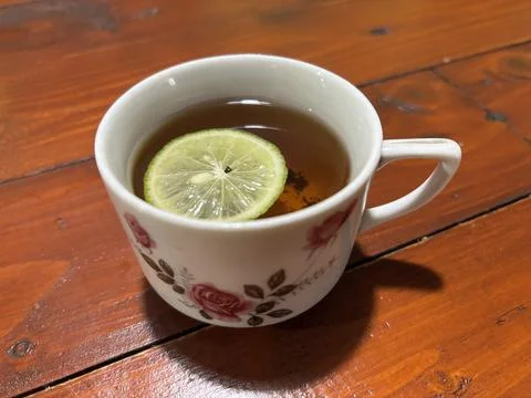 Hot Cup of Tea with Lemon Slice on Rustic Wooden Table Stock Photos