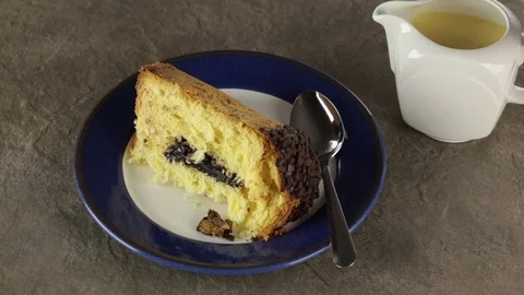 Hot custard being poured over a slice of chocolate filled sponge cake Video stock 72323155