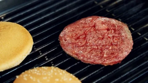 Hot cutlet for a sandwich. Process of cooking meat and buns on grill. Stock Footage 158334164