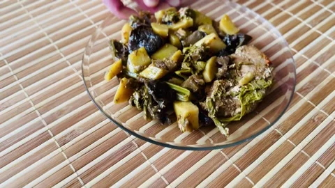 The hot dish includes baked potatoes, eggplant, mushrooms, Far Eastern bracken Stock Footage 316420828