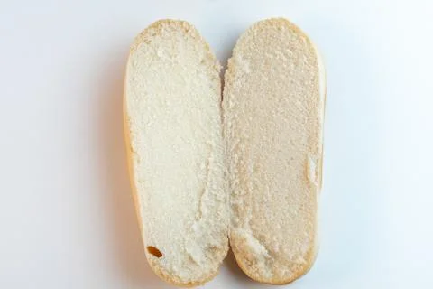 Hot dog bun or bread cut in half on a white background. Top view Stock Photos