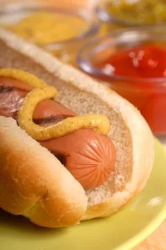 Hot dog with condiments Stock Photos