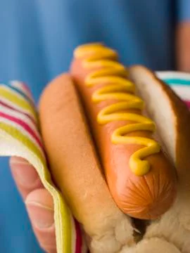 Hot Dog with Mustard in a Napkin Stock Photos