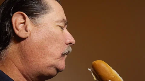 HOT DOG - old man eats a hot dog Stock Footage 53238672