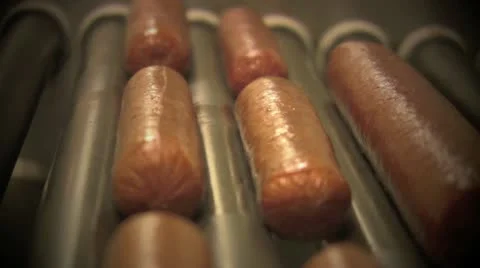Hot Dogs cooking on a Grill Stock Footage 12440512
