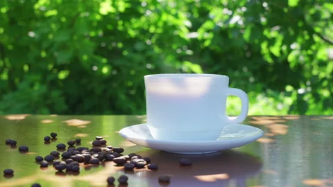 Hot drink in a cup against the background of a summer garden in the morning Stock Footage 202246194